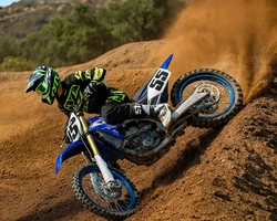 Мотоциклист на соревнованиях едет по земле на кроссовом мотоцикле