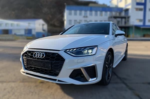 Audi A4 B9 белого цвета на фоне скалы