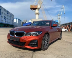 BMW 320i 2022 год оранжевая на фоне порта