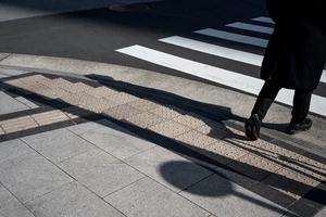 Ноги пешехода идут по зебре