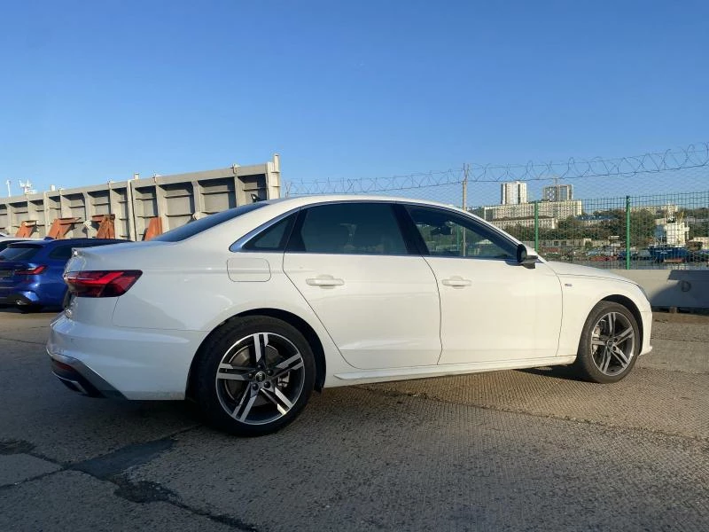 Audi A4 белого цвета вид сбоку