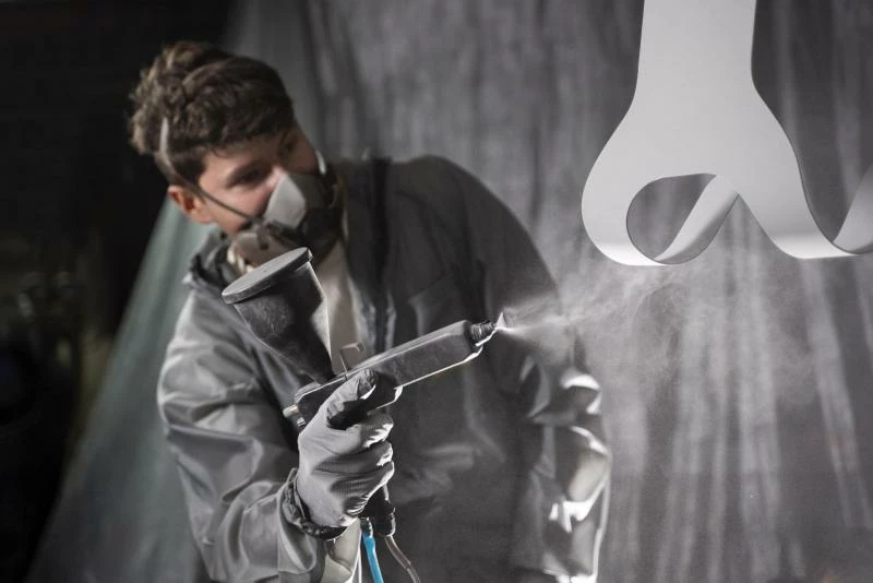 Мужчина красит автомобиль